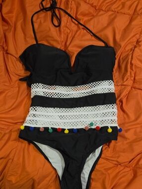 Black One-Piece Swimsuit with White Sheer Crochet Stripes and Colorful Pom Poms